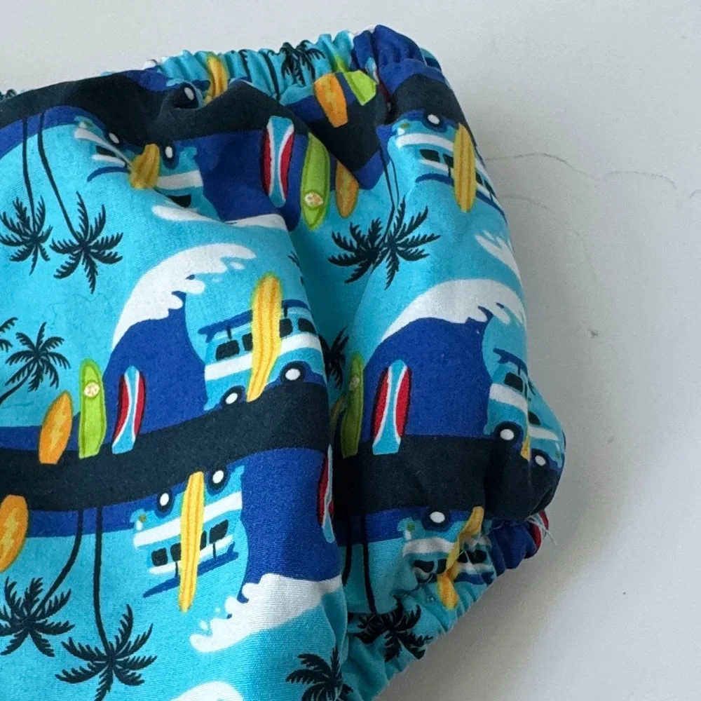 i play. Blue Surfboard and Palm Tree Swim Diaper